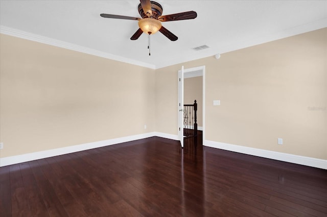 empty room featuring dark hardwood / wood-style flooring, ceiling fan, and crown molding