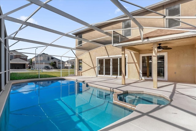 view of pool with an in ground hot tub, glass enclosure, ceiling fan, and a patio area