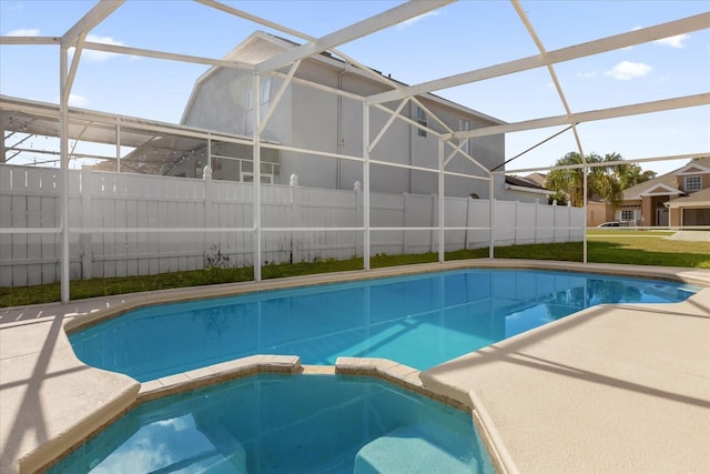 view of pool with an in ground hot tub and a lanai