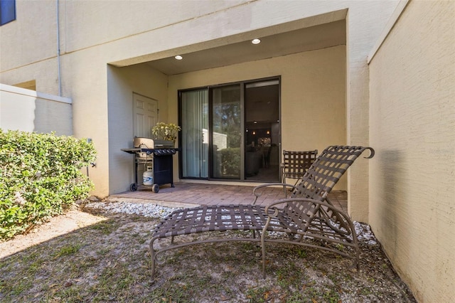 view of exterior entry featuring a patio area