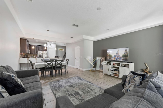 living room with light tile patterned floors and a textured ceiling