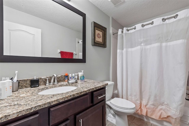 full bathroom with vanity, shower / bath combo, tile patterned floors, toilet, and a textured ceiling