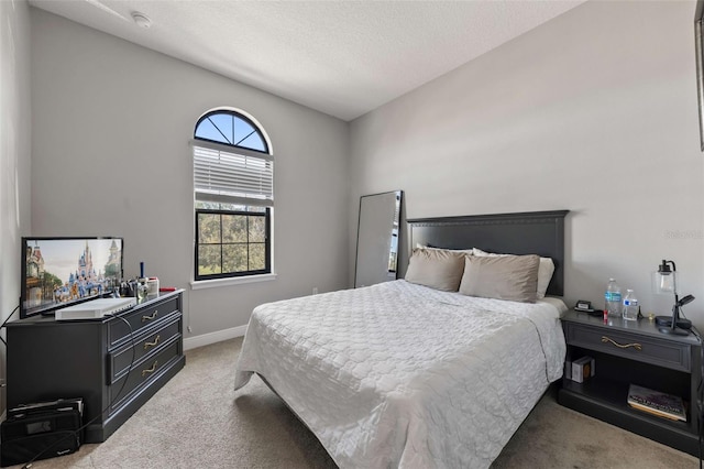 carpeted bedroom with a textured ceiling