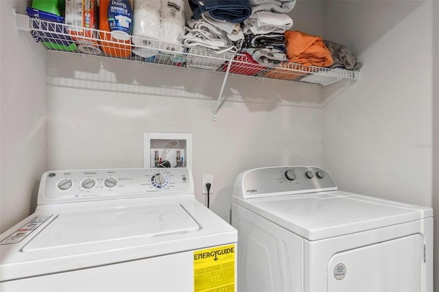 clothes washing area with separate washer and dryer