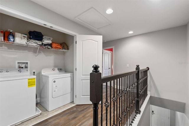 laundry area with washing machine and dryer and dark hardwood / wood-style flooring