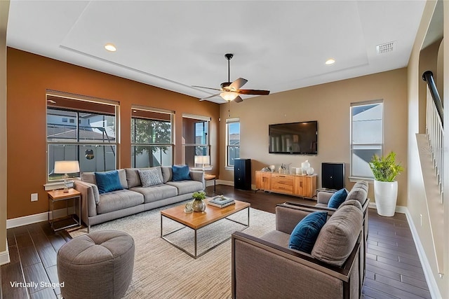 living room with a healthy amount of sunlight and ceiling fan