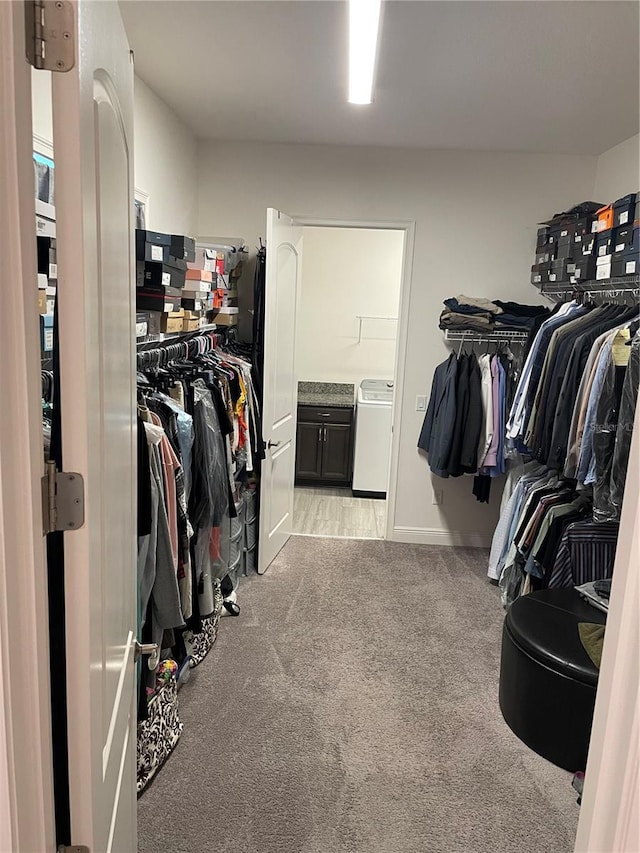 spacious closet with light carpet and washer / clothes dryer