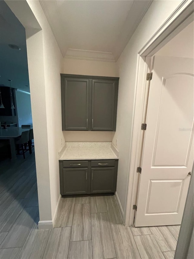 corridor featuring light hardwood / wood-style floors and crown molding