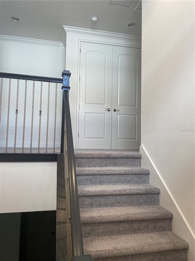 staircase with crown molding