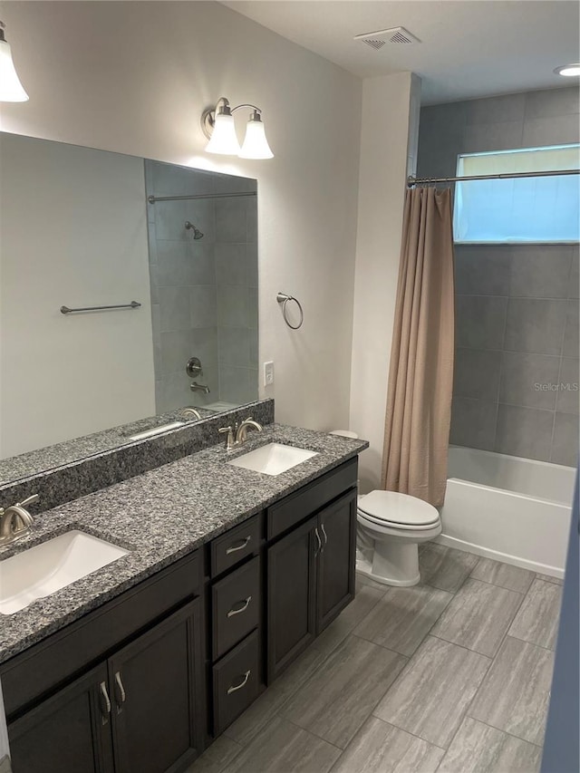 full bathroom with shower / tub combo, vanity, and toilet