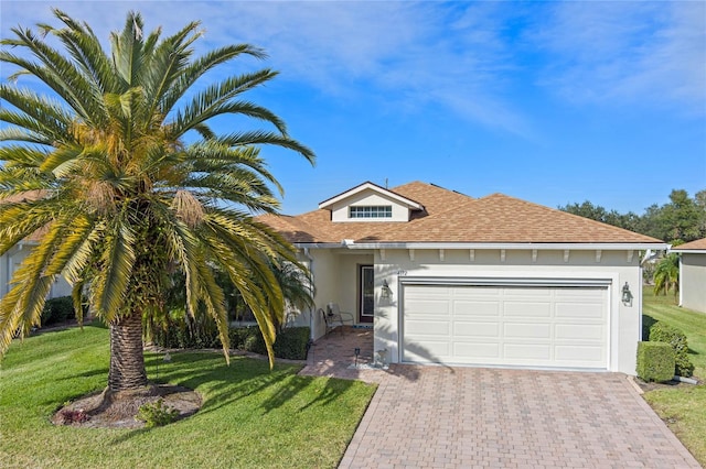 view of front of house featuring a garage and a front lawn