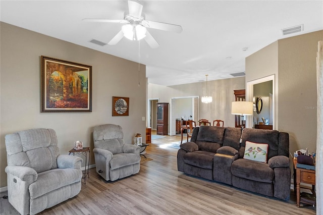 living room with ceiling fan and light hardwood / wood-style floors