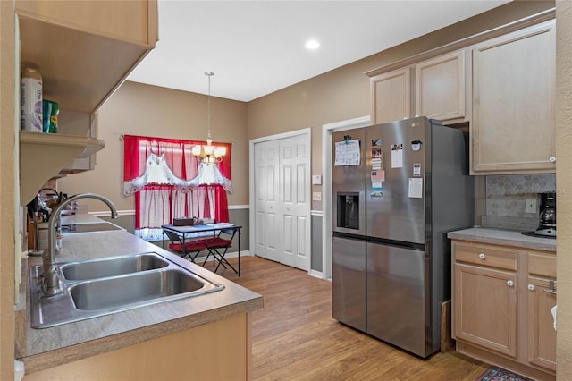 kitchen with stainless steel fridge, light hardwood / wood-style flooring, light brown cabinetry, and sink