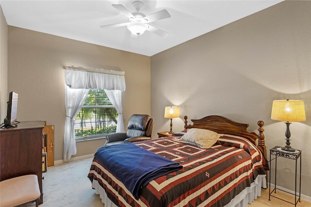 bedroom featuring ceiling fan and light carpet