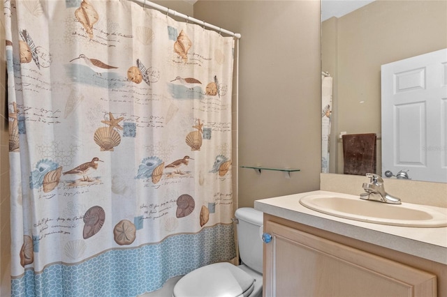 bathroom with a shower with curtain, vanity, and toilet