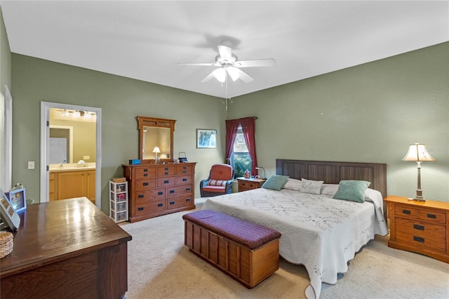 carpeted bedroom featuring ceiling fan and ensuite bath