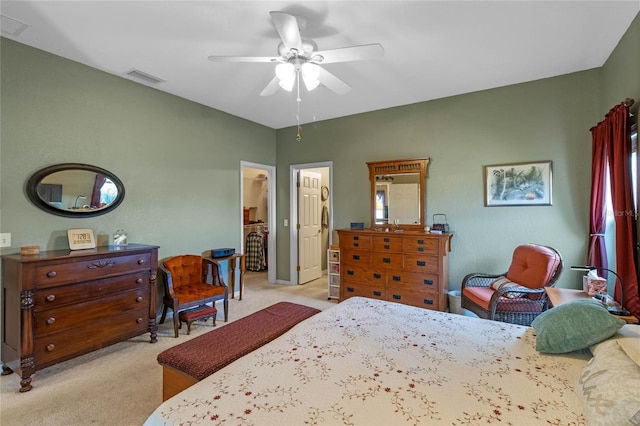 bedroom with ceiling fan and light colored carpet