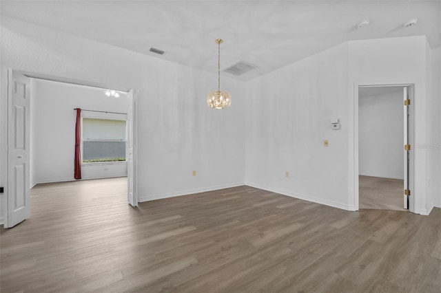 4112 Aberdeen Ln, Lake Wales, FL 33859 - empty room featuring a chandelier and wood finished floors