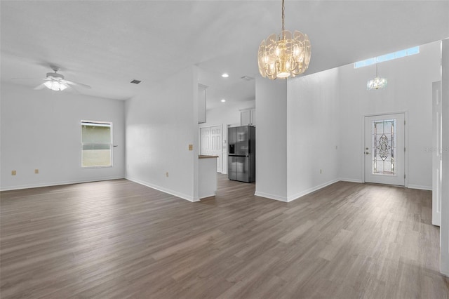 4112 Aberdeen Ln, Lake Wales, FL 33859 - unfurnished living room with a chandelier, wood finished floors, ceiling fan, recessed lighting, and a high ceiling