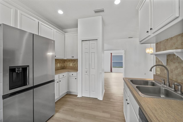 4112 Aberdeen Ln, Lake Wales, FL 33859 - kitchen with stainless steel refrigerator with ice dispenser, white cabinetry, backsplash, light wood-style floors, and recessed lighting