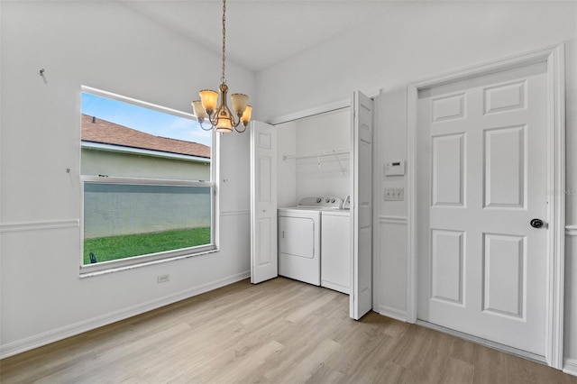 4112 Aberdeen Ln, Lake Wales, FL 33859 - laundry room with washing machine and dryer, light wood-style floors, a chandelier, and healthy amount of natural light