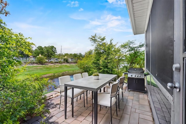 4112 Aberdeen Ln, Lake Wales, FL 33859 - view of patio with outdoor dining area, a water view, and a grill