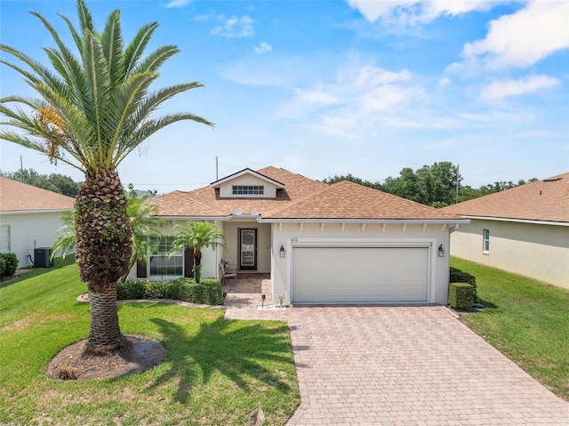 4112 Aberdeen Ln, Lake Wales, FL 33859 - view of front of home with decorative driveway, stucco siding, an attached garage, a shingled roof, and a front lawn