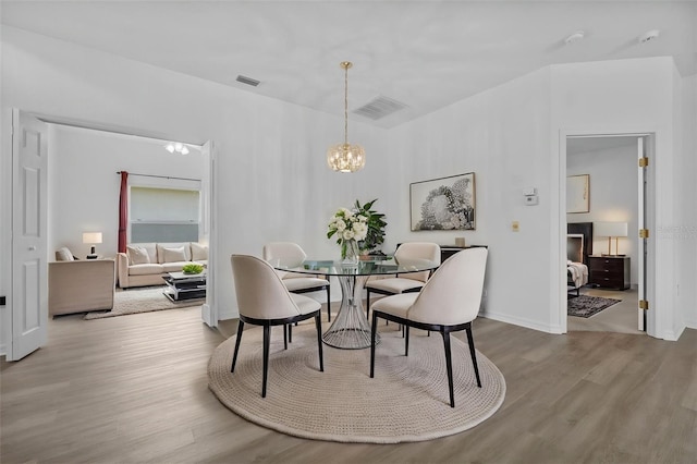 4112 Aberdeen Ln, Lake Wales, FL 33859 - dining space with a chandelier and wood finished floors
