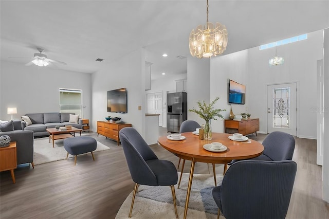 4112 Aberdeen Ln, Lake Wales, FL 33859 - dining room with a chandelier, light wood-style floors, healthy amount of natural light, a high ceiling, and a ceiling fan