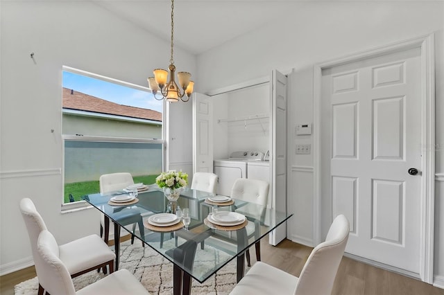 4112 Aberdeen Ln, Lake Wales, FL 33859 - dining room featuring washer and clothes dryer, wood finished floors, and a chandelier