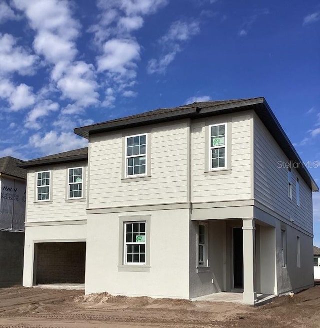 rear view of property with a garage