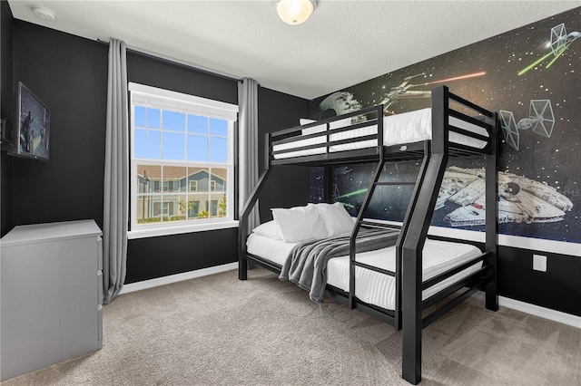 bedroom featuring a textured ceiling and carpet floors