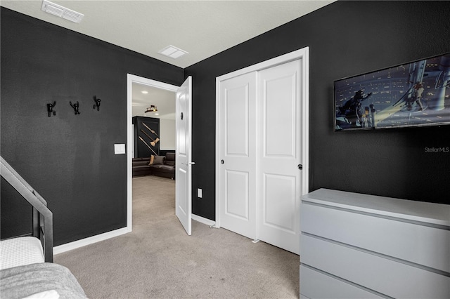 bedroom featuring a closet and light colored carpet