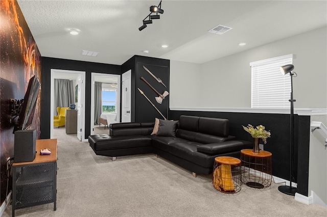 carpeted living room with a textured ceiling