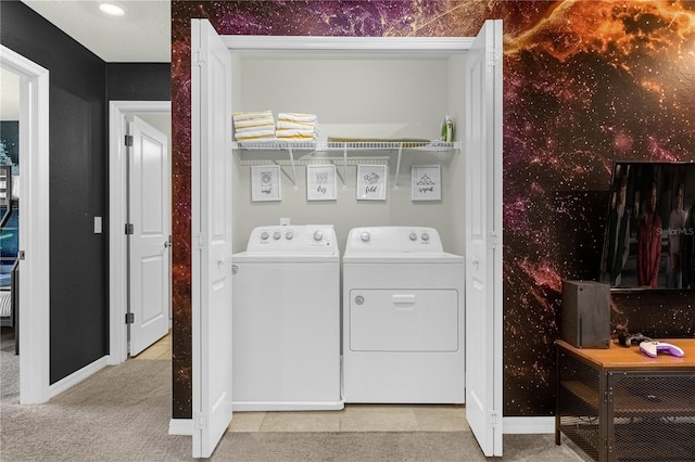 clothes washing area with light colored carpet and independent washer and dryer