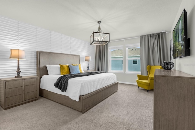 carpeted bedroom featuring an inviting chandelier