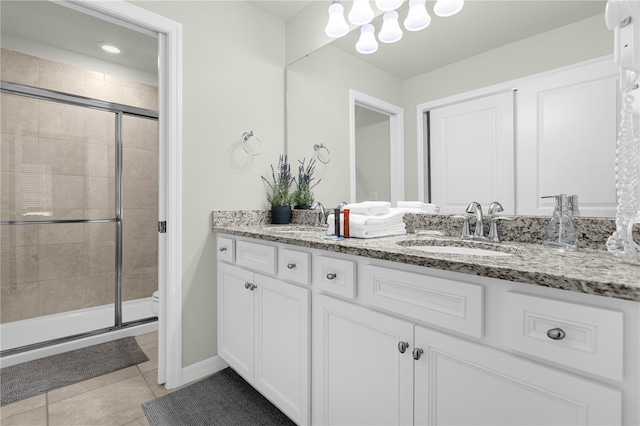 bathroom with tile patterned floors, vanity, and a shower with shower door