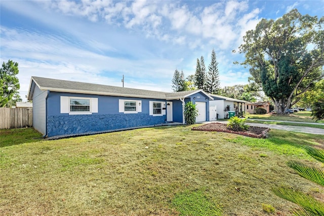 single story home featuring a garage and a front lawn