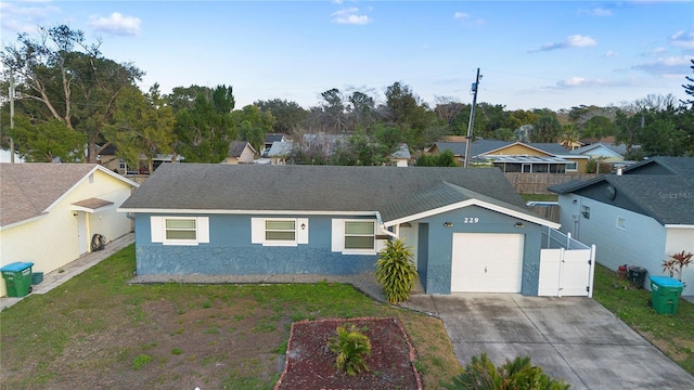 ranch-style home with a garage and a front yard