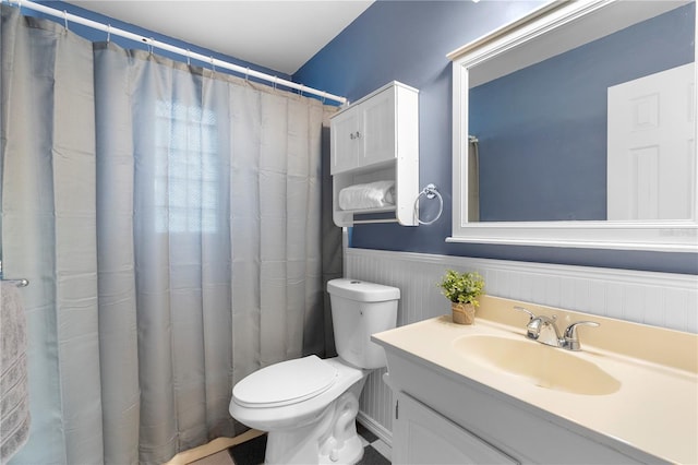 bathroom with vanity, curtained shower, and toilet