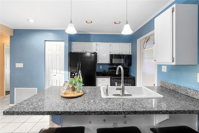 kitchen with white cabinetry, a kitchen breakfast bar, kitchen peninsula, pendant lighting, and black appliances