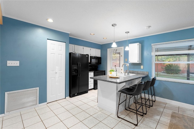 kitchen featuring sink, white cabinetry, black appliances, decorative light fixtures, and kitchen peninsula