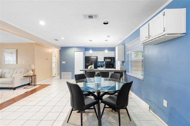 dining room with light tile patterned flooring and a textured ceiling