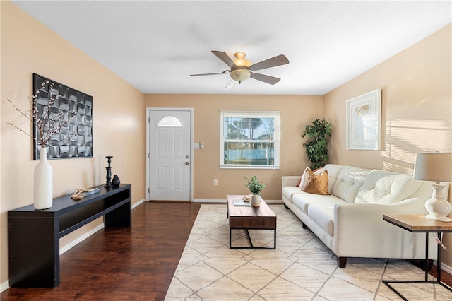 living room featuring ceiling fan, hardwood / wood-style floors, and a textured ceiling