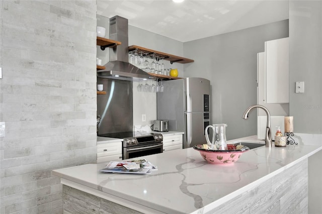 kitchen with exhaust hood, white cabinets, light stone countertops, kitchen peninsula, and stainless steel appliances