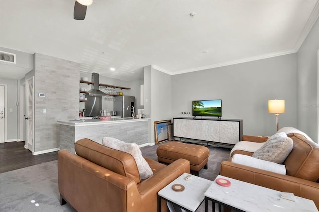 living room with wood-type flooring, ceiling fan, and crown molding