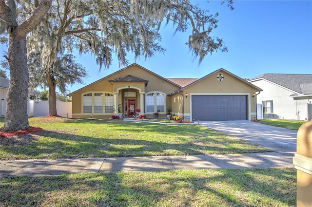 single story home featuring a garage and a front yard