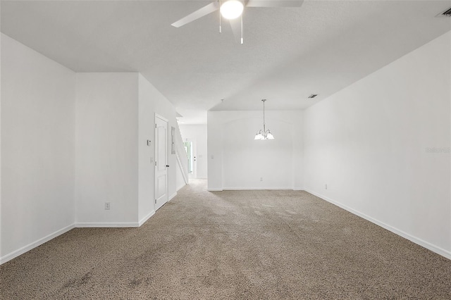 carpeted empty room with ceiling fan with notable chandelier