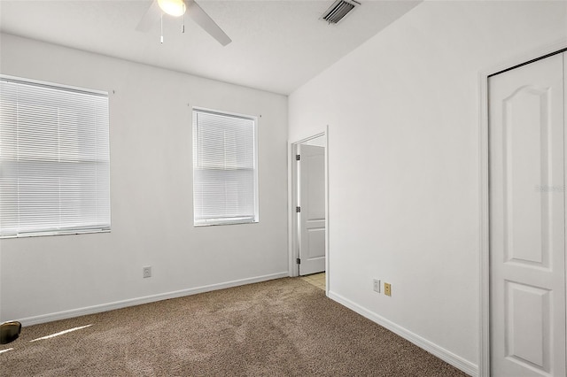 unfurnished bedroom with ceiling fan and light carpet