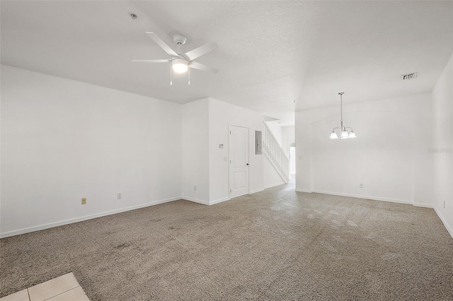 unfurnished living room featuring electric panel and ceiling fan with notable chandelier